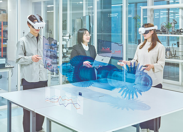 XRゴーグルを着用して仮想空間上の機械部品を確認する学生たち
